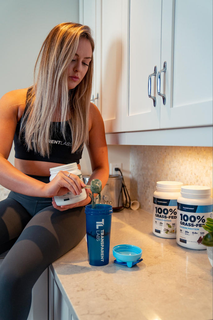 A girl scooping protein powder to tumbler
