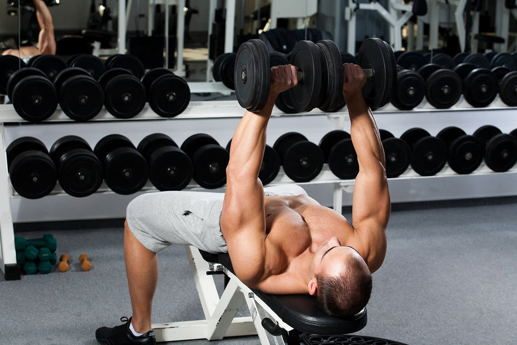 free weight exercises: Man lifting at the gym