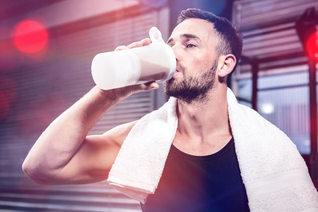 Athlete drinking a protein shake in the gym